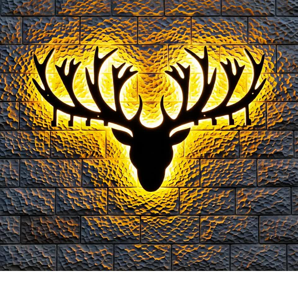 This stunning backlit CNC metal wall art features a bold silhouette of a majestic deer head with large antlers, precisely laser-cut from metal. The design is mounted against a textured brick wall and enhanced with warm yellow LED backlighting, creating a dramatic halo glow effect. The contrast between the dark metal silhouette and the illuminated background adds depth, luxury, and a modern 3D appearance. Perfect for living rooms, offices, cafes, or premium interior spaces, this decorative metal piece combines contemporary design with rustic elegance, making it a powerful statement wall décor element.