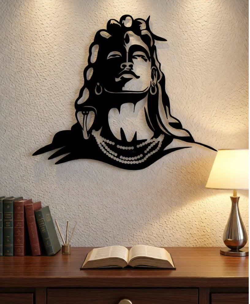Bring spiritual depth and powerful artistic expression into your space with this Lord Shiva Metal Wall Art. Featuring a striking silhouette of Shiva’s serene face, adorned with symbolic elements such as flowing hair, crescent moon, and sacred ornaments, this artwork represents peace, strength, and divine consciousness. The bold yet minimalist design creates a calming presence while making a strong visual statement. Expertly crafted from high-quality metal, this wall art is precision cut to highlight fine facial details and smooth contours. The matte black powder-coated finish enhances its modern appeal while ensuring durability and long-lasting beauty with minimal maintenance. The clean silhouette design allows it to stand out beautifully against light-colored walls. Perfect for meditation rooms, living spaces, yoga studios, or spiritual corners, this artwork blends devotion with contemporary décor. It harmonizes effortlessly with modern, minimalist, and spiritual interior styles, adding both meaning and elegance to your environment. Designed for easy wall mounting, this piece transforms empty walls into a focal point of calm and inspiration. Whether placed in a personal prayer area or as a statement décor piece, it brings balance, serenity, and artistic sophistication to any space.