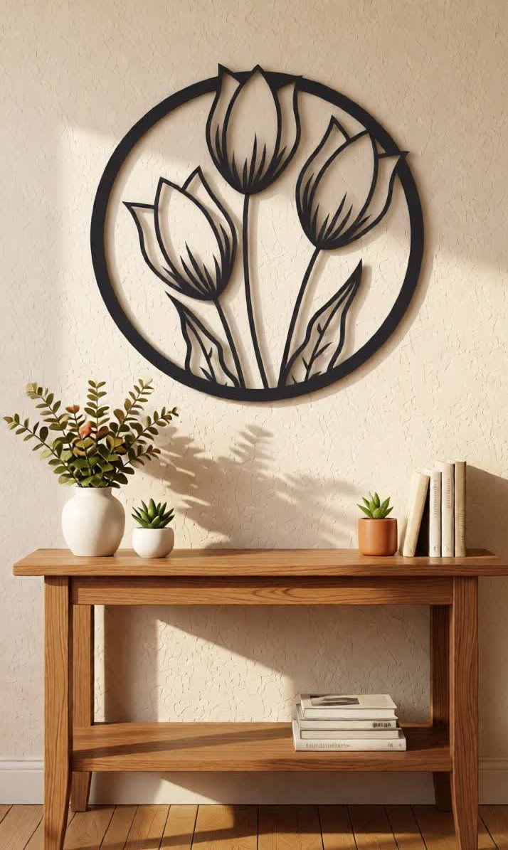 Elevate your interiors with this Elegant Tulip Flower Metal Wall Art, a beautiful combination of natural inspiration and contemporary design. Featuring three graceful tulip flowers enclosed within a circular frame, this artistic wall décor symbolizes beauty, growth, and positivity while adding a refreshing botanical touch to your home. The intricate precision laser-cut metal design highlights the delicate tulip petals and slender stems, creating a visually captivating centerpiece for your wall. The matte black finish enhances the elegance and depth of the floral pattern, making it a stylish décor element that complements both modern and minimalist interiors. This wall décor is perfect for those who appreciate nature-inspired décor and sophisticated design, bringing warmth and elegance to any room.