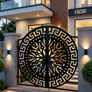 A luxury modern home entrance at night under a clear sky, featuring a custom-fabricated, backlit CNC laser-cut black and gold gate. The black central medallion is surrounded by a prominent gold Greek Key border, and intricate gold filigree is lit from behind.